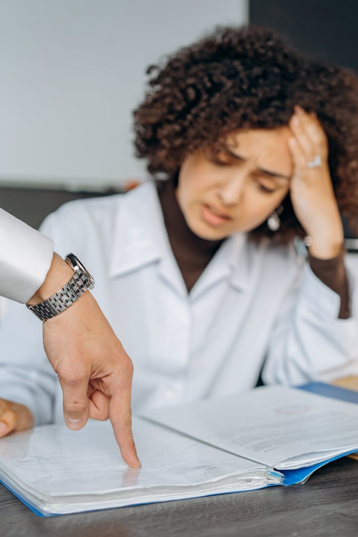 Portrait of a stressed woman employee with afro hair facing work pressure.